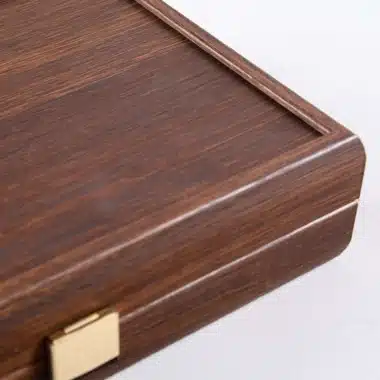 Detailansicht der Ecke der dunklen Nussbaumholzbox mit goldenem Verschluss