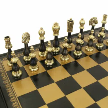 Nahaufnahme der schwarzen und goldenen Figuren auf dem Holzschachbrett